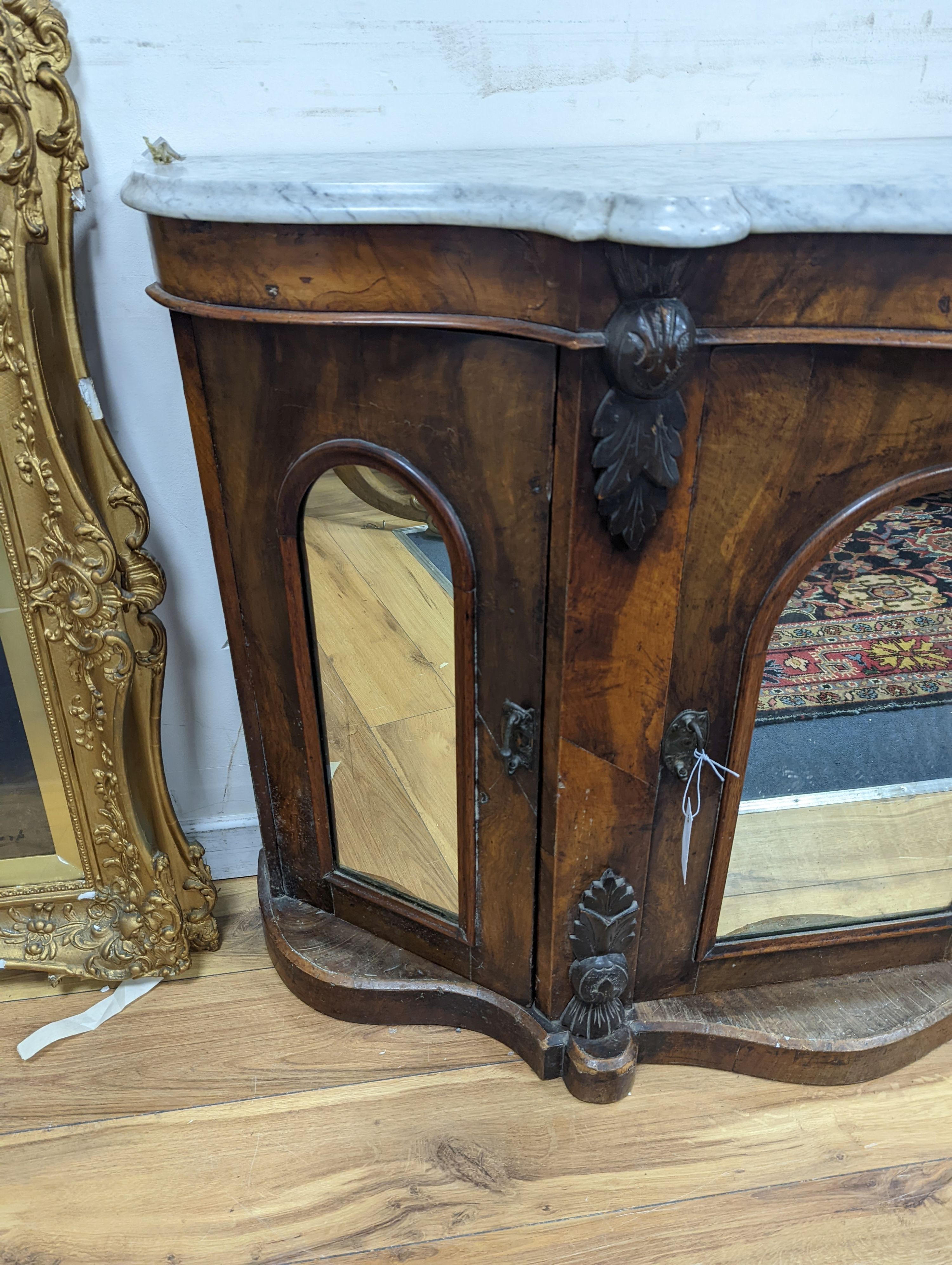 A late Victorian walnut and marble topped serpentine front side cabinet, width 120cm, depth 36cm, height 83cm